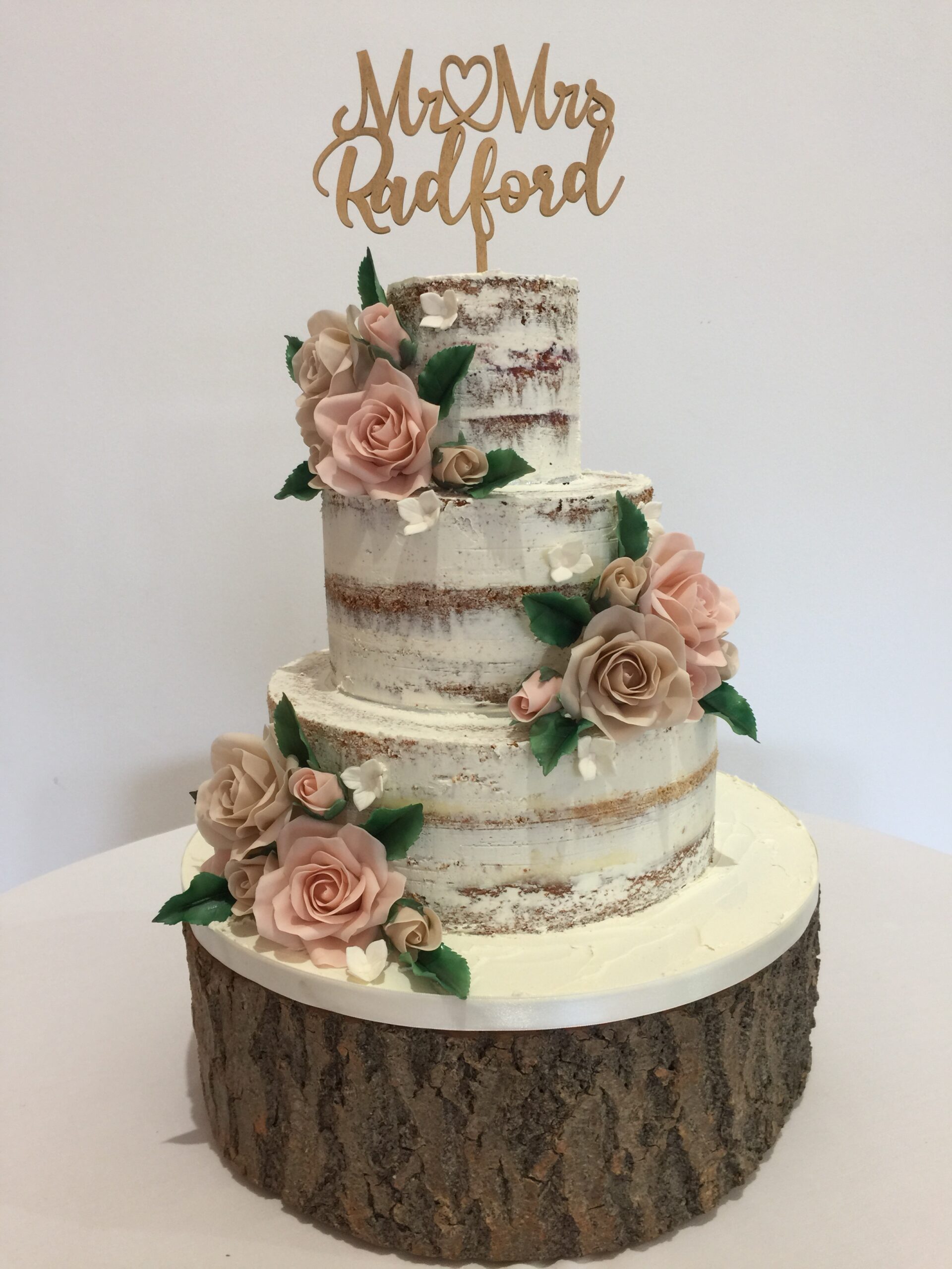 Semi Naked wedding cake with sugar roses & a bespoke cake topper at Swancar Farm Country House, Nottinghamshire
